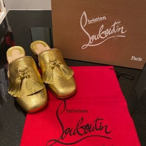 Gold Louboutin mules with tassels